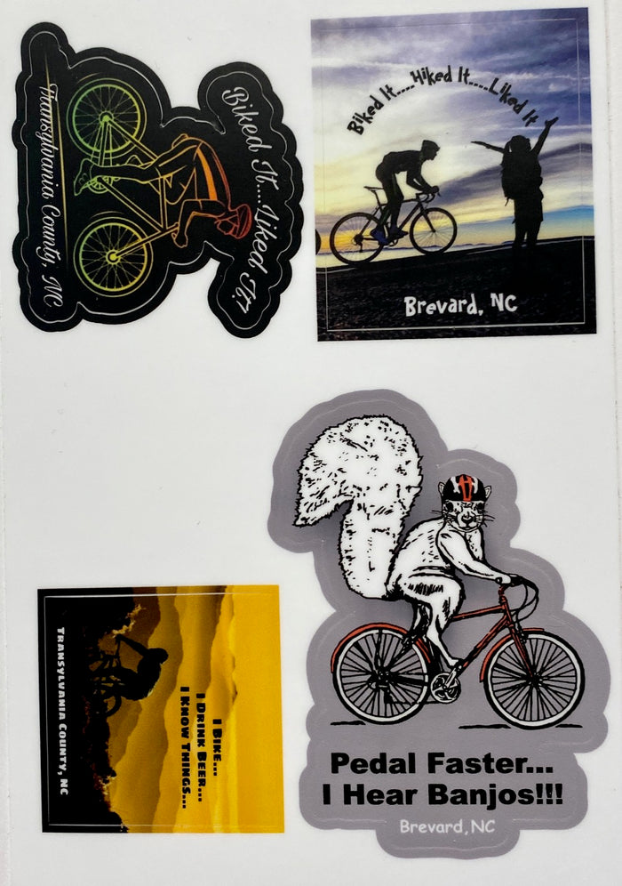 A set of waterproof vinyl decals featuring various designs related to biking and the location Brevard, NC. The decals include images of a bicycle, a person biking, and whimsical illustrations with text.