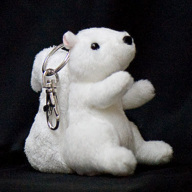 A stuffed white squirrel key chain with black eyes and nose, sitting upright.